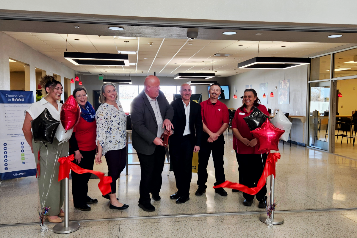 ribbon cutting group smiling