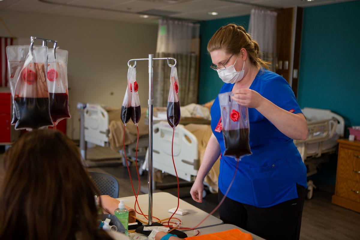 medical assistant holding a bag of blood