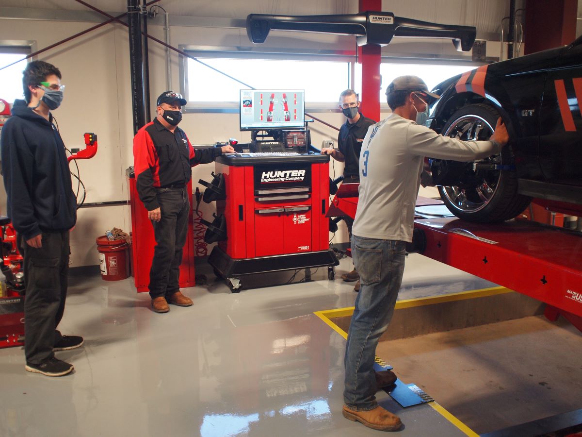 automotive students working on a car