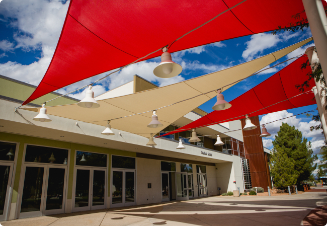 Front entrance to new building. Modern architecture with glass doors and tall windows.