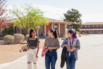 Three female students walking on the Douglas Campus