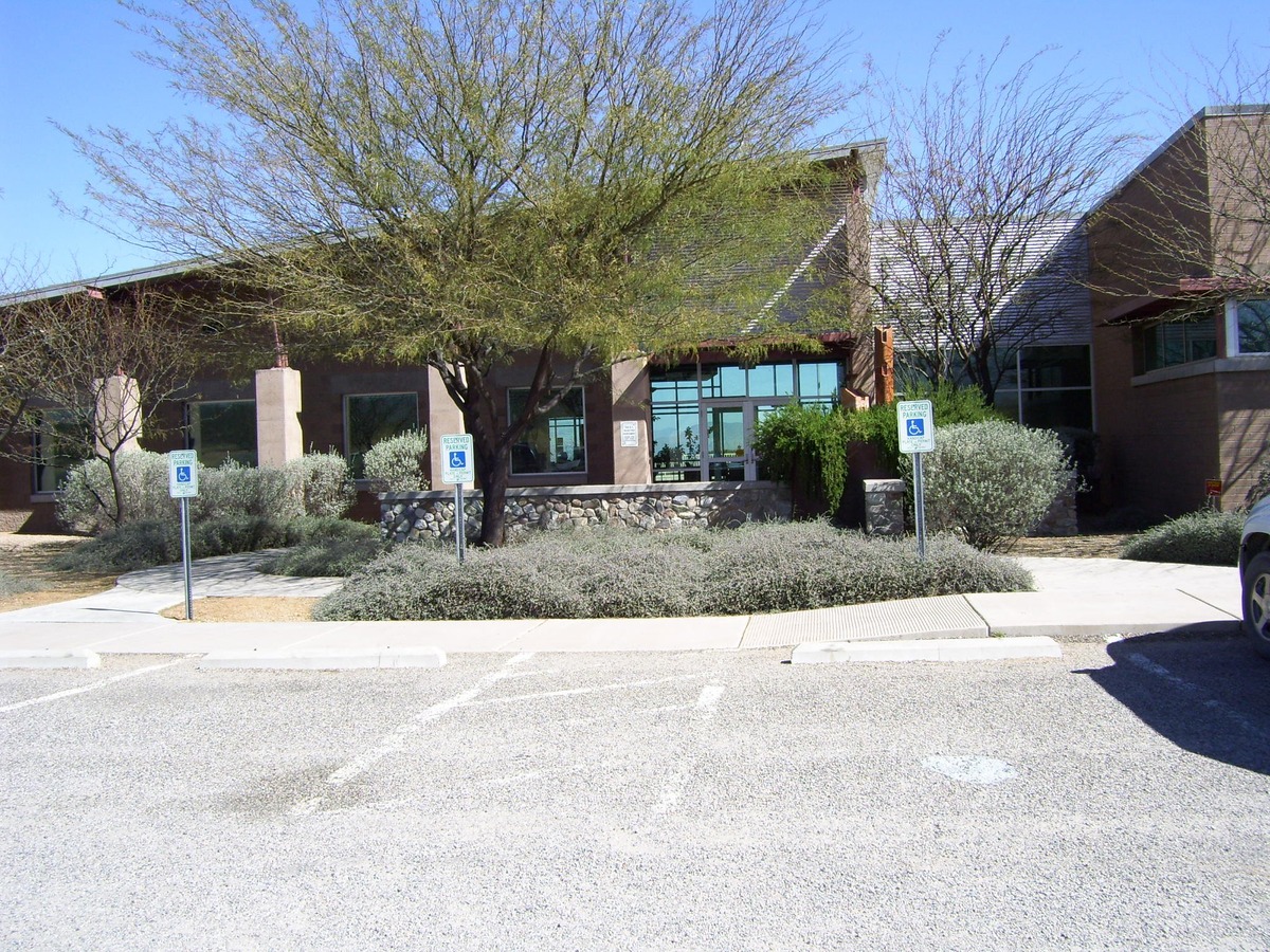 Front entrance to new building. Modern architecture with glass doors and tall windows.