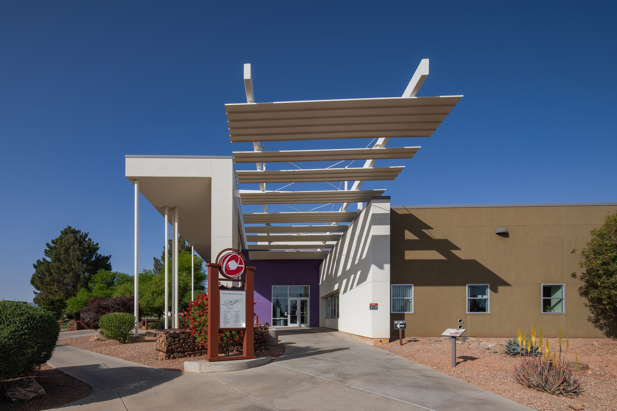 Front entrance to new building. Modern architecture with glass doors and tall windows.