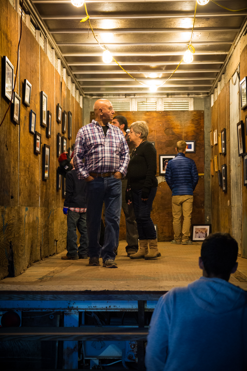 Festival attendees admiring photography display